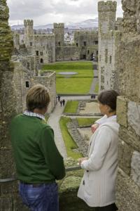 Caernarfon Castle Two people standing on the top of the tower at caernarfon castle